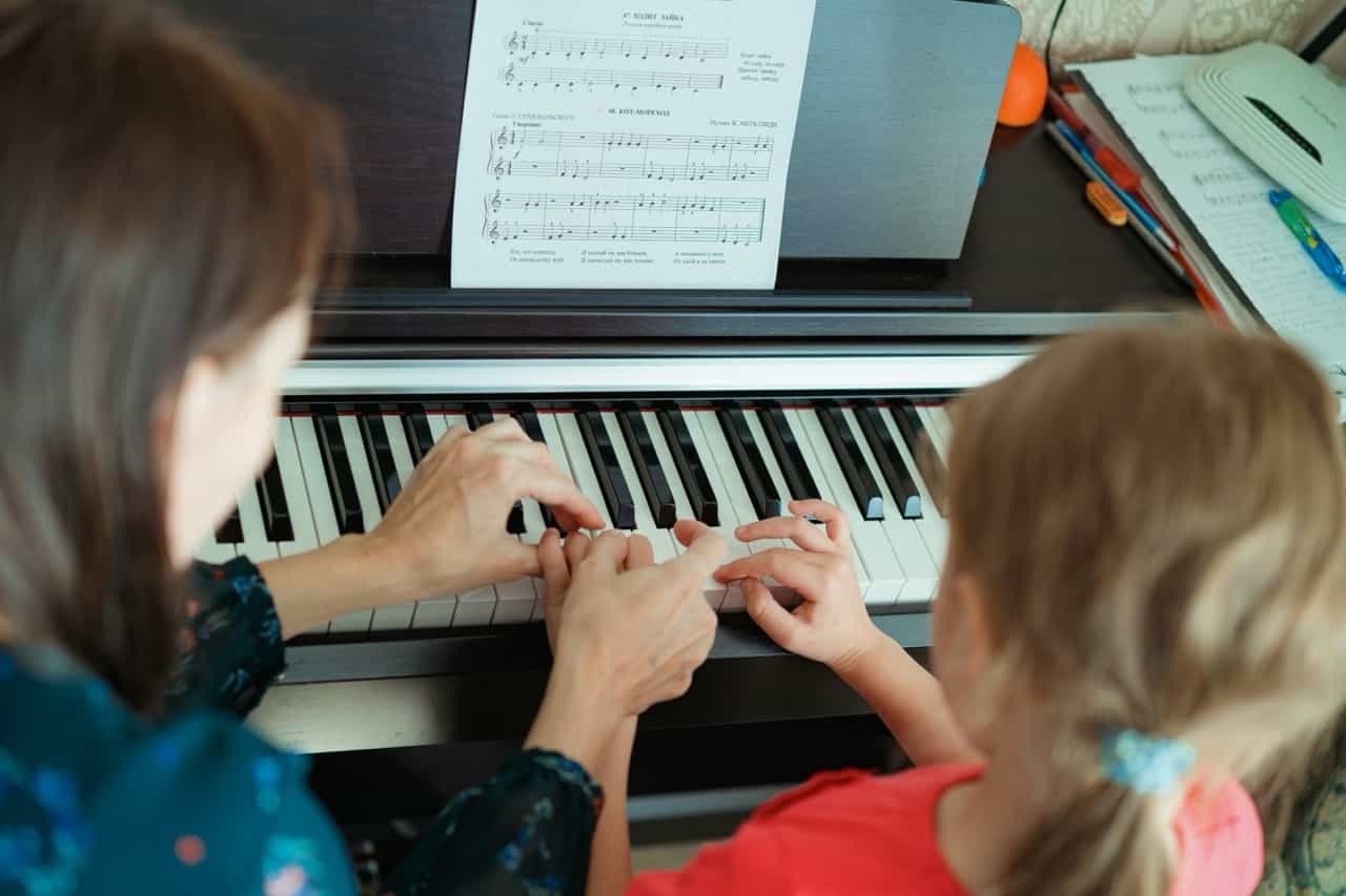 Music teacher with student